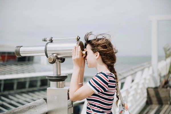 young woman looking out over city